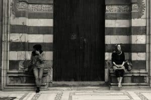 man in black jacket sitting on the floor