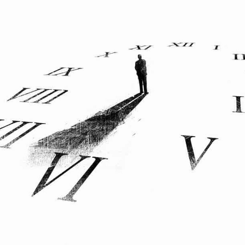 mans-shadow-forming-clock-hands-ikon-images